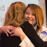 Haylea D. Estright, of Brisbin, accepts a hug from Samantha M. Weaver, learning laboratory coordinator for nursing.