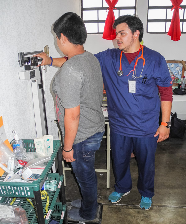 Ramirez gathers a patient’s weight.