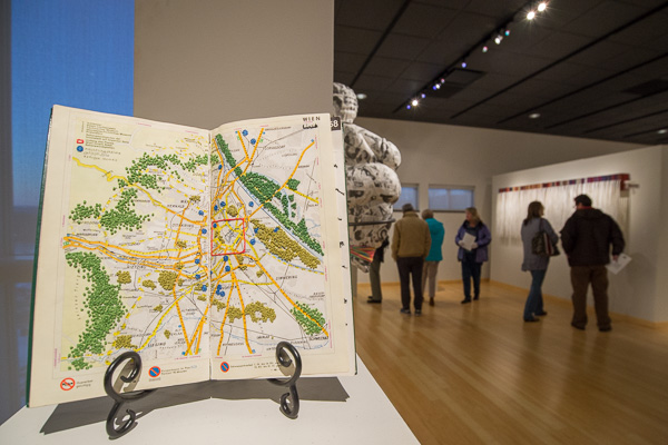 “Refugee Atlas 2016” is one of the creations by Heather Beardsley, who utilizes embroidery and cutwork on European driving atlases to map out locations of current refugee crises.