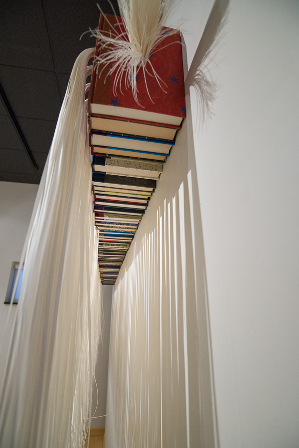 Influenced by icicles, Perry’s “154 Ripples: icicle” flows with fabric, wood, aluminum, paper and altered books.