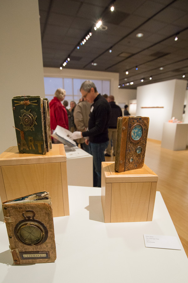 Seth Apter’s mixed media works invite exploration to find hidden treasures inside pockets (with gallery gloves provided to visitors who want to handle the books).