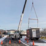 Allison Crane and Rigging prepares to move the press box into place.