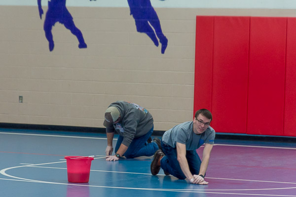 Students Tanner A. Huff, of Altoona, and Timothy J. Lamont, of Eldred, scrub the floor at Firetree Place, a community center on Campbell Street in Williamsport. Huff majors in engineering design technology; Lamont in heating, ventilation and air conditioning technology.