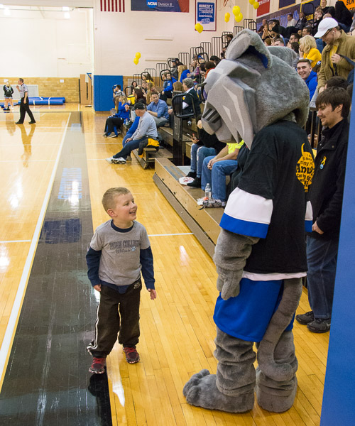 A young fan mingles with the mascot.