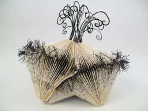 Peggy Johnston’s “Gemini Pod 2,” recycled book, wire, thread, beads, shell, 5.5 inches by 6.5 inches by 6 inches
