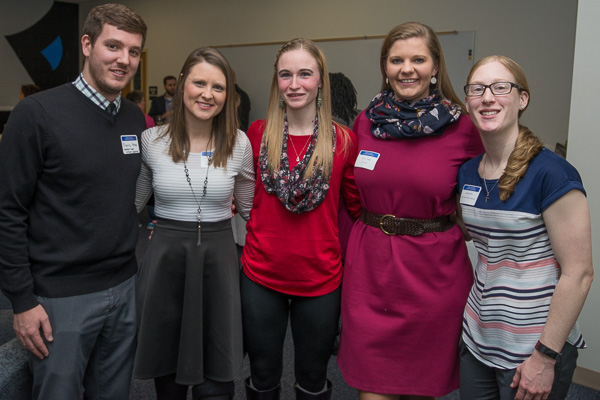 Hoops lovers reunite! From left: Travis Heap, assistant women’s basketball coach; former women’s basketball players Erin C. (Mahoney) Heap (dental hygiene, ’09 and ’10), Alicia N. Ross (nursing, ’17) and Logan; and Lauren Healy, head women’s basketball coach.