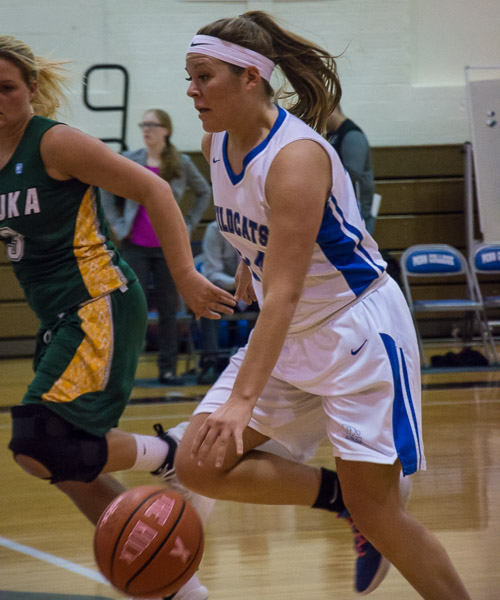 Guard Jane M. Herman, who led the home team's scorers with 10 points that night, dribbles past a Keuka defender.