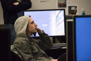 Thomas M. Czaus II, an information technology sciences-gaming and simulation major from Morgantown, lends an intently listening ear.