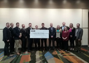 Penn College was one of five recipients of a National Housing Endowment grant, which was formally awarded during the 2018 National Association of Home Builders International Builders’ Show in Orlando, Fla. Accepting the check are (from left) instructor Levon A. Whitmyer; students Hayden N. Beiter, of Williamsport; Michael J. Deragon, of Fort Washington; Caleb M. Burk, of Sunbury; Nathaniel M. Barbolish, of Nicholson; Aaron F. White, of Westover; Ryan Z. Zwickle, of Slatington; Justin W. Bates, of Hawley; Casey L. Grim, of Red Lion; Henry A. Rainey, of Jersey Shore; Katherine L. Mertes, of Williamsport; and Hanna J. Williams, of Marion, N.Y.; and instructor Barney A. Kahn IV. 