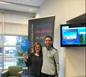 Student development assistant Ryan Monteleone delivers a balloon to Heather L. Allison, a workforce development consultant, among the college donors observing a birthday in February.