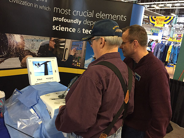 Scott A. Geist (right), director of the college's Surgical Technology Program, guides a visitor through a mock laparoscopy.