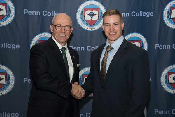 Steven P. Johnson (left), benefactor of the Steve and Mary Ann Johnson Scholarship and a member of the Penn College Board of Directors, shakes the hand of his recipient, John A. Gondy.