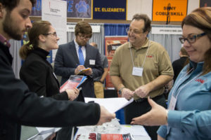 Plastics and polymer engineering technology student Olivia C. Ferki (second from left), of Richboro, Bucks County, discusses her potential future during a visit to the Lane Enterprises Inc. booth at Penn College’s Spring 2018 Career Fair, which attracted nearly 240 employers offering more than 2,700 jobs and internships.