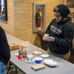Providing sustenance for the event during "Peanut Butter and Jelly Time" is Community Peer Educator Alexis J. Medero, a civil engineering technology student from Levittown.