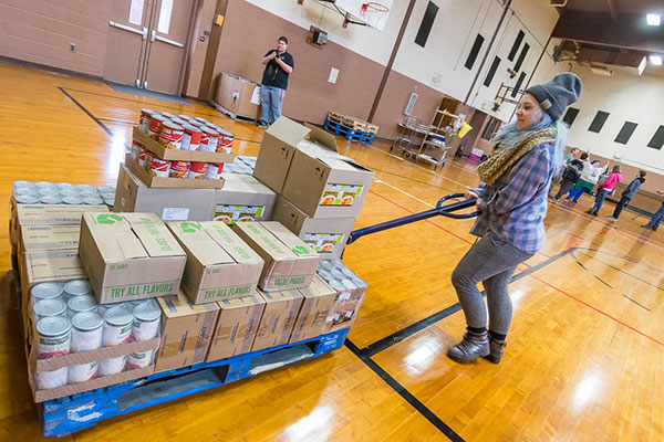 ... including Shelby E. Lynch, of Williamsport, an individual studies major maneuvering packaged food across the gymnasium floor. 