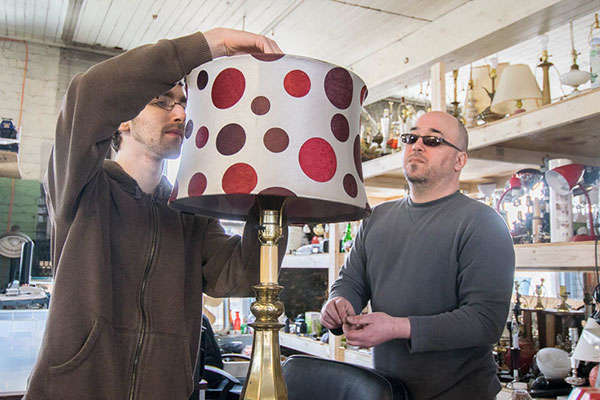 Jake C. Forelli (left), an engineering design technology student from Damascus, and resident Steve Sykes assemble lamps to be sold at the American Rescue Workers Thrift Store.