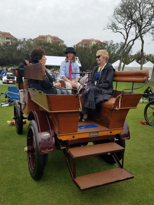Owner Patricia B. Swigart (left) is among those enjoying a ride with driver Luke C. Miller across the grounds of the illustrious Amelia Island event.