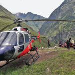 A helicopter lands in a Himalayan village to transport Daniel J. LaSota, ’09, to his next assignment. LaSota is a project manager for Steadfast Nepal, helping to replace homes destroyed by 2015 earthquakes. 