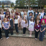 Taking advantage of daylight saving time and springlike weather, honorees gather on the PDC back patio for a group photo.