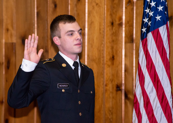 The Stars and Stripes provides an apt backdrop as Weinrich takes his oath.