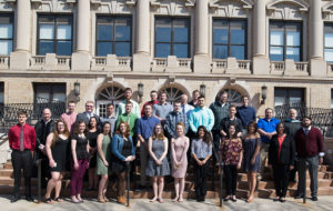 Many of the morning's student VIPs joined their co-advisers for an outdoor memento of their achievement.