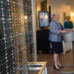 With the donor wall as a visually stunning accent, the president welcomes the crowd as Loni N. Kline, vice president for institutional advancement, stands ready to hand out gifts of appreciation. 
