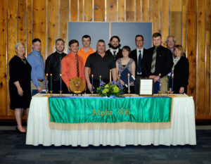 Seven of the newest Alpha Chi members mark their induction with administrative mentors after the ceremony.