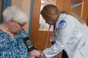 Penn College nursing student Rachel E. Farber, of Altoona, measures the blood pressure of librarian Helen L. Yoas at the close of a class offered by nursing students on “Reducing Risks: Understanding Metabolic Syndrome.” 