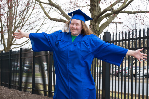 Laura E. Cholko, of Port Carbon, who will graduate with an associate degree in landscape/horticulture technology: plant production emphasis, excitedly tries on and shows off her new cap and gown. She plans to adorn her mortarboard with an unassailable boast: 