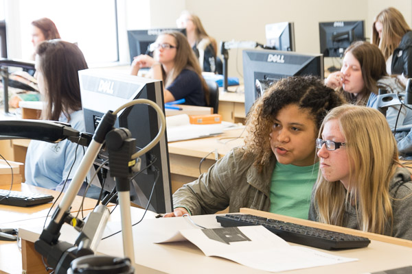 A young guest (right) gets some hands-on guidance from Rossell Burgos, an architectural technology major from Hazleton.