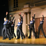 ... the Wildcat Dance Team fervently moves through a display of musical styles and costume changes.