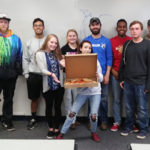 FYE students of Edward J. Almasy (left) flaunt the pizza they won as the semester's most engaging class.
