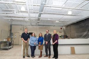 Gathered at the The Dr. Welch Workshop: A Makerspace at Penn College (under construction in the Carl Building Technologies Center at the college) are, from left, alumnus James Ryan, distribution technician for PPL; alumna Michelle Bennett-Knouse, journeyman electrician for PPL; Tracie Witter, PPL regional affairs director; Kyle A. Smith, executive director of the Penn College Foundation; and Elizabeth A. Biddle, director of corporate relations for Penn College.
