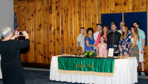 An obliging college president assumes photo duty so no family member is left out of the picture.