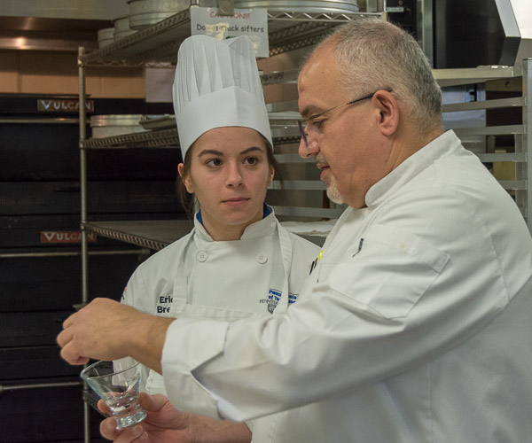 Chef John G. Scourlas, senior pastry chef for Levy Restaurants, explains his concept for presenting an alternate dessert option with baking and pastry arts student Erica Breski, of Harrisburg.