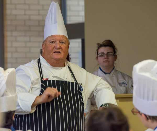 Rosenberg talks about the evening’s menu and order of service – and provides words of encouragement and thanks – during a staff “lineup” before guests arrive for the Visiting Chef Dinner.