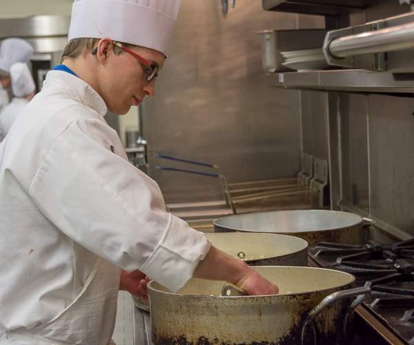 Christopher M. Bashaw, of Jersey Shore, prepares the sweet-onion and Honeycrisp apple chutney that would be served with the main course: a slow-smoked and apple-brined rack of pork.