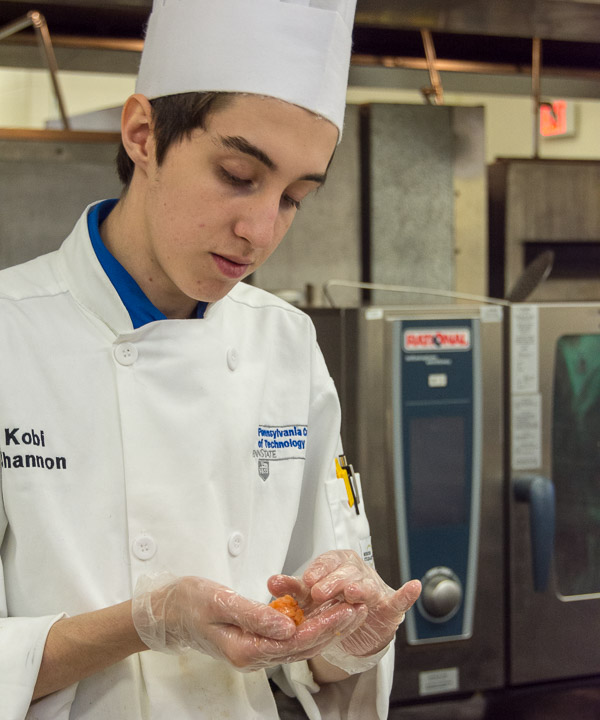 Kobi A. Shannon, of Lewistown, forms a smoked-salmon lollipop.