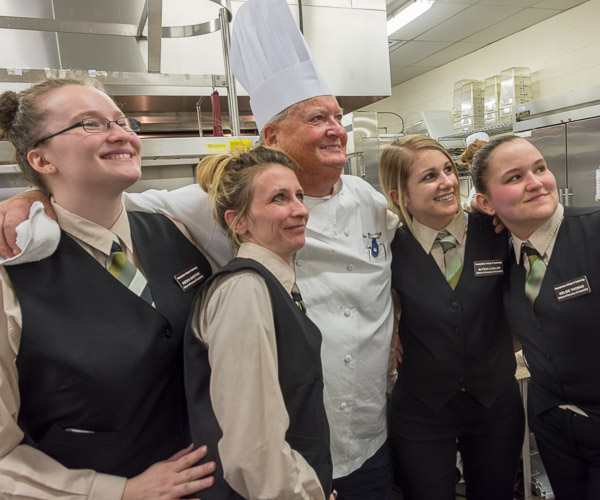 While guests enjoy dessert, students gather for photos with Rosenberg. 