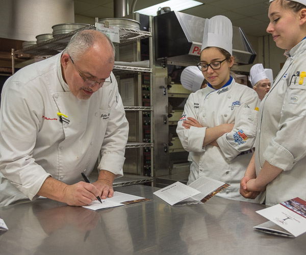 A Visiting Chef Series tradition: Students ask the visitors to autograph the evening’s menu.