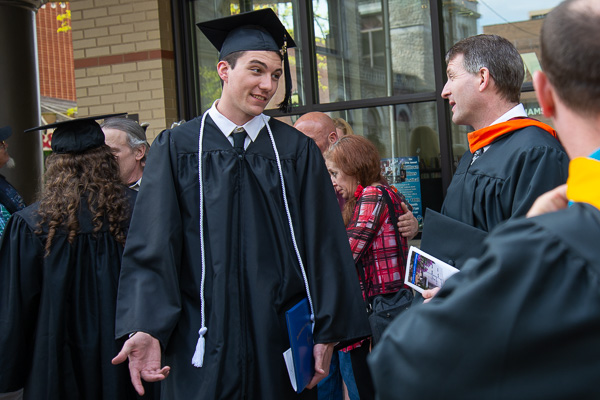 Following Friday's ceremony, engineering design technology graduate William C. Hayden enjoys one last conversation with instructor Craig A. Miller.