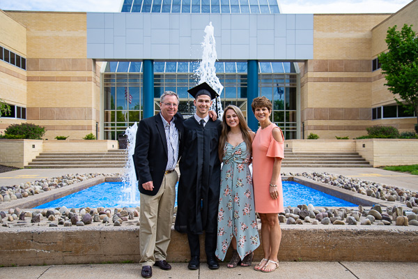 Evan M. Astley, his parents and sister enjoy a photo op back on campus.  He graduated in manufacturing engineering technology and is from Harrison City.