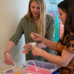 Cori Jo "C.J." Ruble (left), a general studies major from Mifflintown, and Rachel L. Hafer, an early childhood education student from Boyertown, create sand art.
