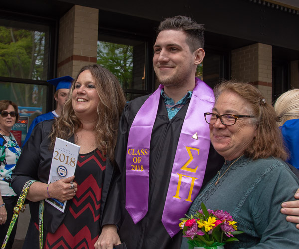 Former Wildcat basketball player Dustin O. Baughman, of Bethlehem, surprised Judy Quinti (right), assistant professor of exercise science, with flowers and a ticket to his commencement ceremony. Quinti developed exercise regimens for Baughman throughout his collegiate career. At left is Baughman’s mother, Trixie.