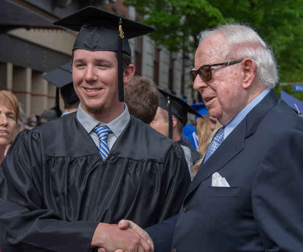 Manufacturing engineering technology graduate Markus P. Weber, of Port Tobacco, Md., receives congratulations from his grandfather, who received a degree in engineering 63 years ago from The Manhattan College and was pleased to see his grandson follow his footsteps.