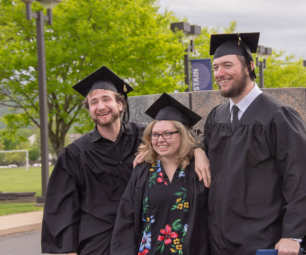 Graphic design graduates Joseph N. Colyer, of Selinsgrove, Morgan L. Royer, of Centre Hall, and Austin L. Fulton, of Montoursville, pose for photos near the college main entrance ...