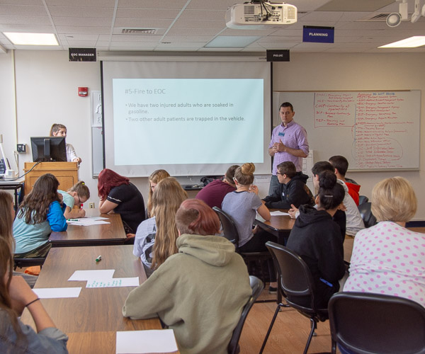 Students from Hughesville Jr./Sr. High School and Milton Middle School learn about the work of an emergency operations center. The session was led by David E. Bjorkman (right), instructor of emergency management and social science.