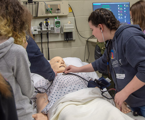 North Penn-Liberty Jr./Sr. High School students learn the capabilities of SimMan in a session led by Jessica L. Bower, nursing simulation laboratory coordinator.