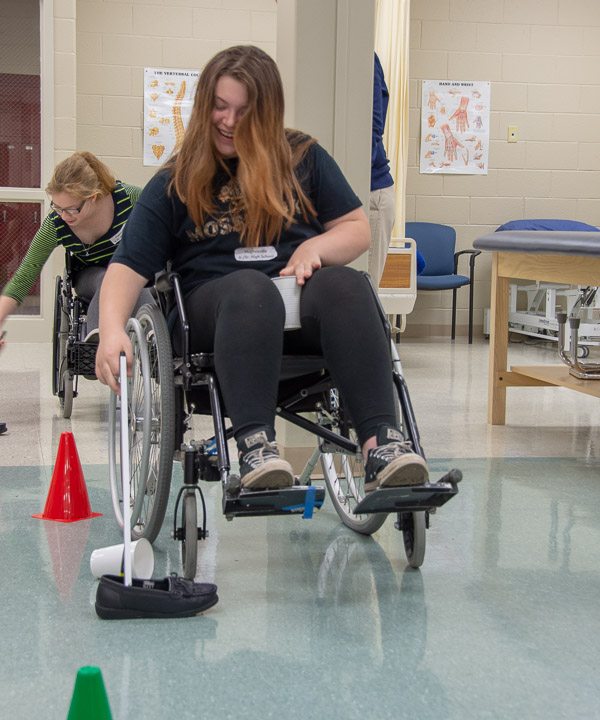 Hughesville Jr./Sr. High Schoolers use grabbers to pick a variety of items from the floor while manipulating wheelchairs in the physical therapist assistant lab.