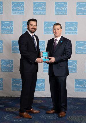 Kenneth P. Hellberg Jr. (left), building performance specialist for Penn College’s National Sustainable Structures Center, accepts the Northwest Energy Efficiency Council Energy Star award from Jonathan Passe, residential branch chief for Energy Star.